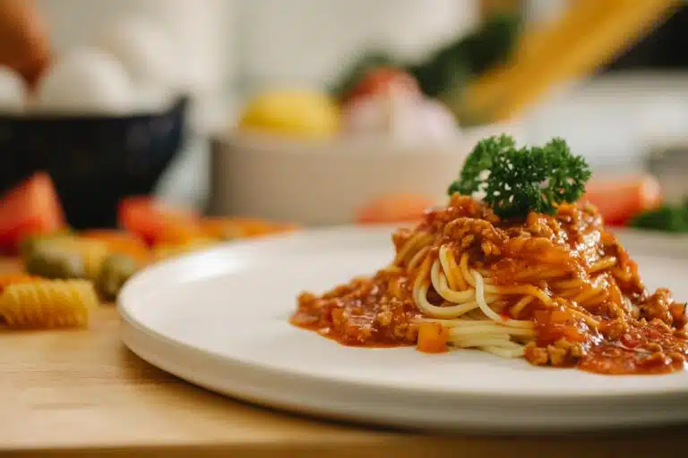 A bowl of delicious marinara pasta topped with fresh basil and Parmesan, embodying the essence of Italian cuisine.