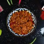 A simmering pot of Olive Garden's meat sauce, showcasing the rich blend of tomatoes, ground beef, and Italian herbs.