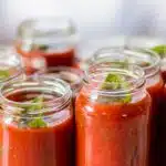 Jar of Prego sauce next to a bowl of pasta, questioning if it's a marinara sauce.