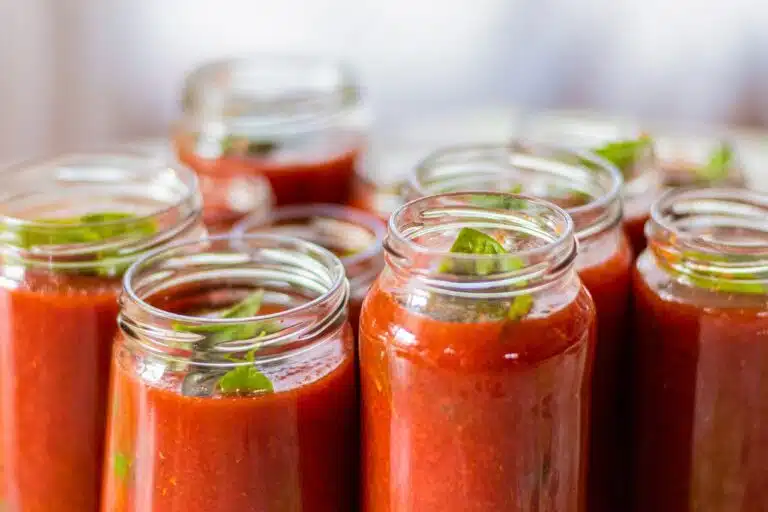 Jar of Prego sauce next to a bowl of pasta, questioning if it's a marinara sauce.