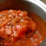 A bowl of pasta with marinara sauce next to a bowl of spaghetti in spaghetti sauce, highlighting the differences between the two sauces.