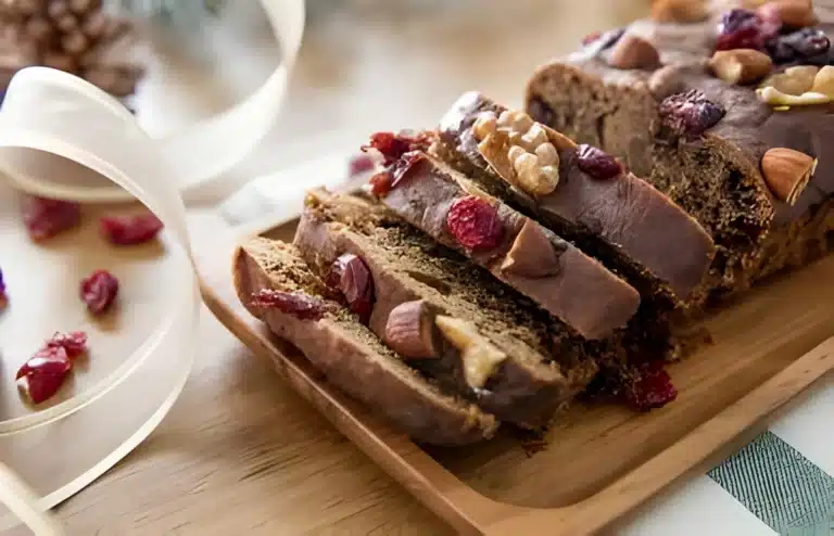 Sliced almond nut cake on a plate, showcasing the rich texture and almond topping