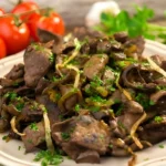 A succulent beef liver steak sizzling on a hot skillet, ready to be served.