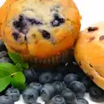 Freshly baked blueberry bagels on a cooling rack, highlighting the vibrant blueberries and golden-brown crust