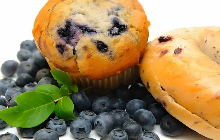 Freshly baked blueberry bagels on a cooling rack, highlighting the vibrant blueberries and golden-brown crust