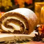 Libby's pumpkin roll on a festive table, showcasing the spiraled pumpkin cake with creamy filling.