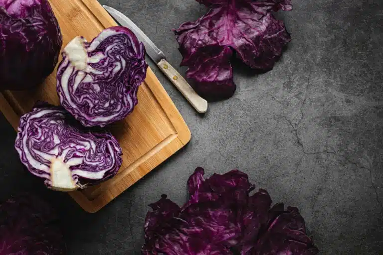 A vibrant dish of roasted purple cauliflower garnished with fresh herbs